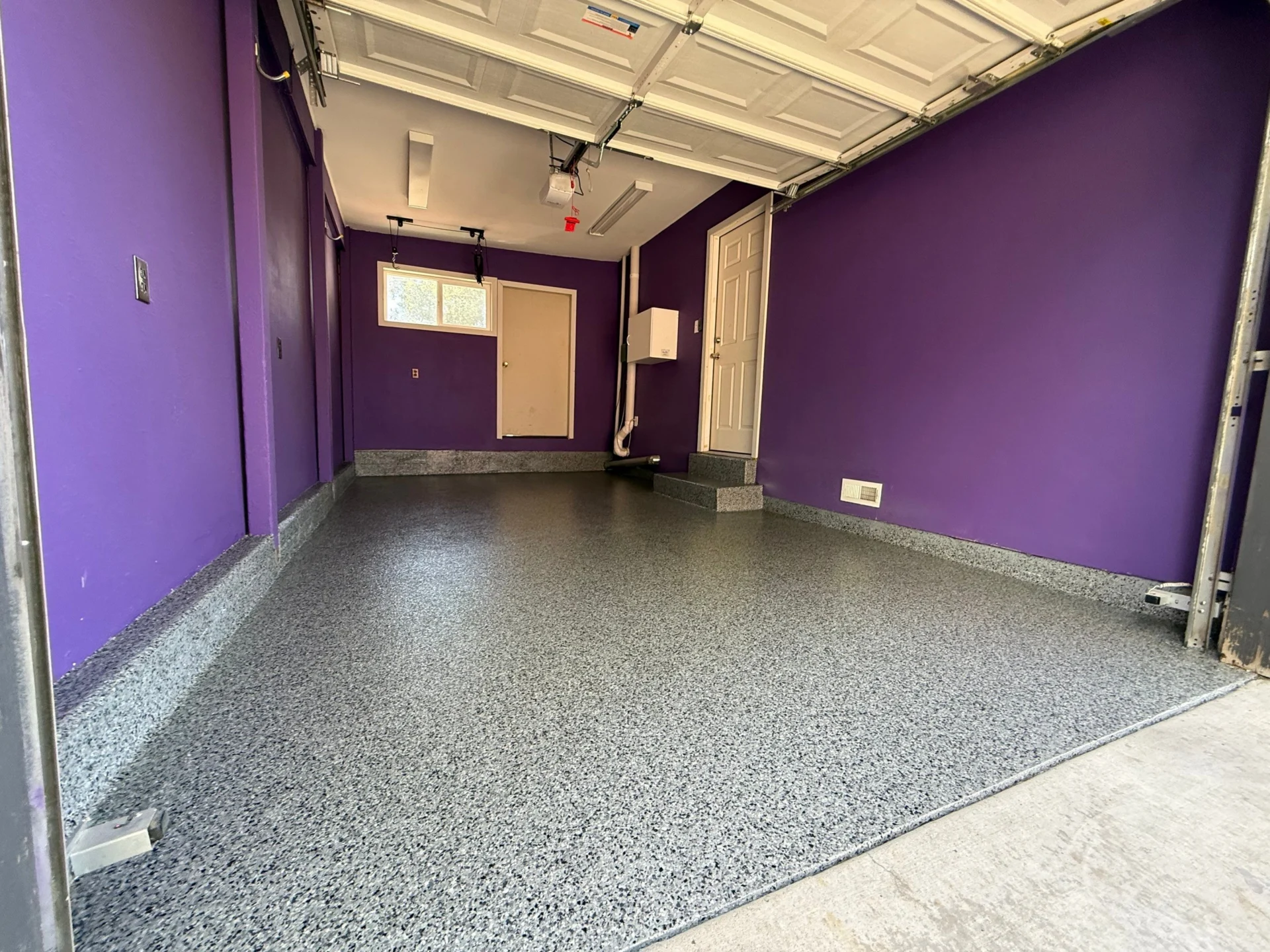 Purple garage with speckled gray epoxy floor